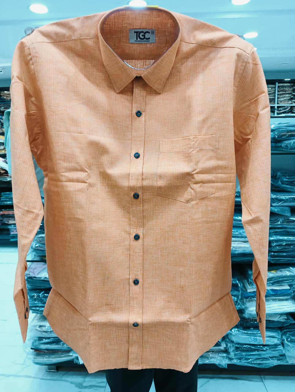 Beige shirt with black buttons
